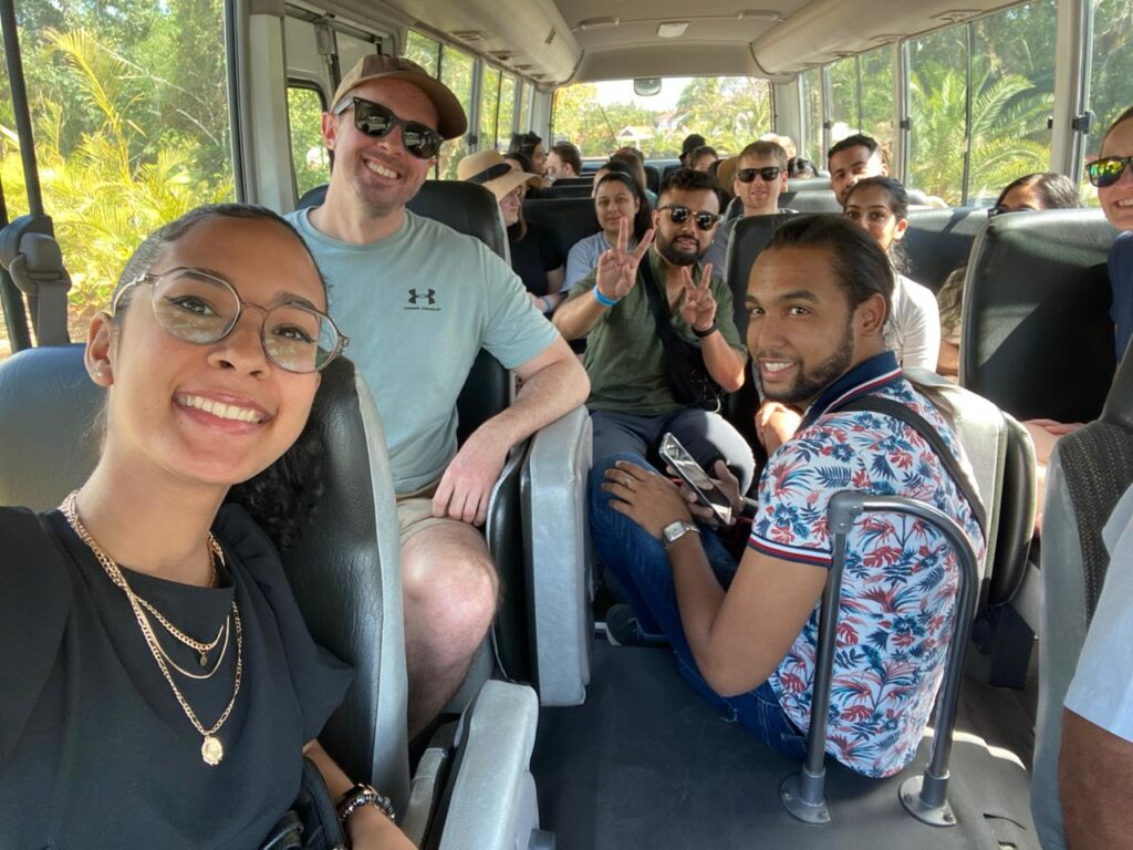 A group of people smiling on a bus
