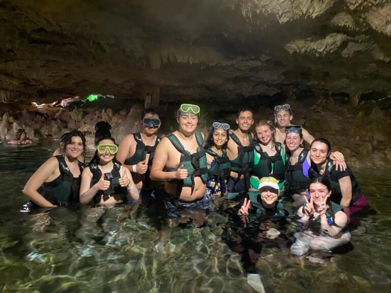 A group of people in scuba gear inside a cave